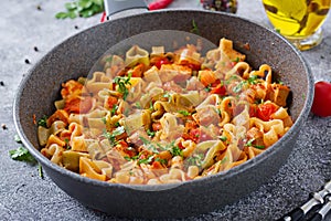 Pasta in the shape of hearts with chicken and tomatoes in tomato sauce