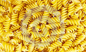 Pasta in the shape of a spiral. Macro photo of pasta. Pasta background. Pasta in bulk