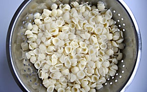 Pasta shells in a colander