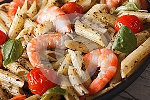 Pasta with shrimp and pesto on a plate macro. horizontal