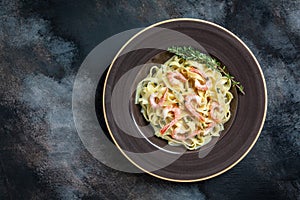 Pasta with shrimps, bechamel sauce and thyme, fettuccine pasta. traditional Mediterranean linguine with seafood, Italian cuisine.