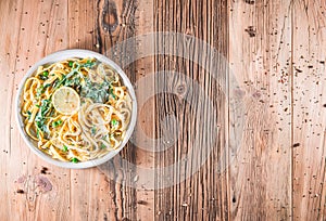 Pasta with a sour cream lemon and herbs on wooden table