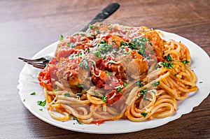 Pasta spaghetti with meatballs in tomato sauce on a plate