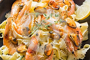 Pasta spaghetti reginette with seafood, shrimps, mussels. Close up. Traditional dish in Italy