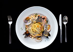 Pasta spaghetti seafood with mussels and shrimps and tomatoes, with parsley