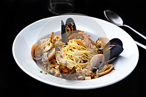 Pasta spaghetti seafood with mussels and shrimps and tomatoes, with parsley