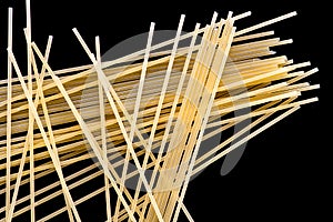 Pasta, spaghetti, shells, rings, bows on a black or white background top view