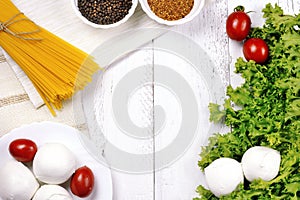 Pasta spaghetti tomato mozzarella pepper on wooden background