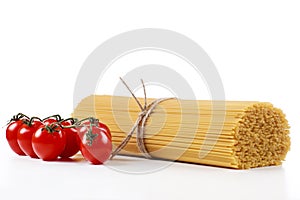 Pasta spaghetti on a white background with fresh tomatoes photo