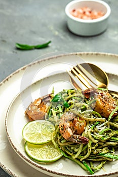 Pasta spaghetti zucchini basil pesto sauce and grilled shrimp, Vegetarian vegetable pasta, Food recipe background. Close up