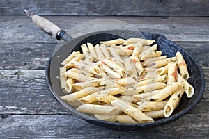 Pasta with spices in an old frying pan