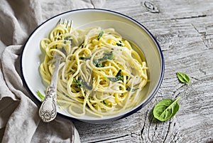 Pasta with spinach and cream sauce on vintage enameled plate