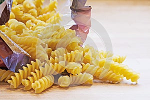 Pasta in spiral shape fall out of a bag