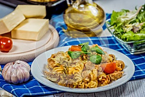 Pasta with tomato, basil leaf, garlic and parmesan