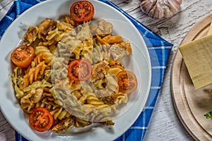 Pasta with tomato, basil leaf, garlic and parmesan