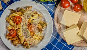 Pasta with tomato, basil leaf, garlic and parmesan