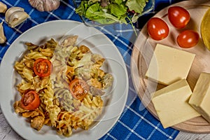 Pasta with tomato, basil leaf, garlic and parmesan