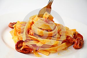 Pasta with tomato sauce, sun dried tomatoes and cheese