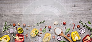 Pasta, tomatoes and ingredients for cooking on rustic background, top view, border. Italian food concept photo