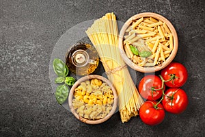 Pasta, tomatoes and olive oil on black