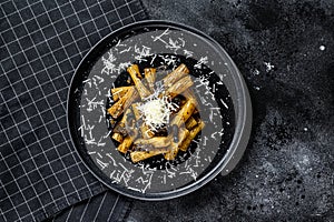 Pasta tortiglioni with black truffle, white mushroom, Cream Sauce and parmesan cheese. Black background. Top view