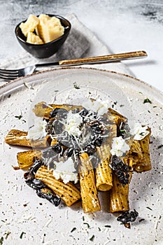 Pasta tortiglioni with black truffle, white mushroom, Cream Sauce and ricotta cheese. Gray background. Top view