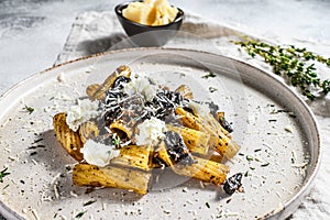 Pasta tortiglioni with black truffle, white mushroom, Cream Sauce and ricotta cheese. Gray background. Top view