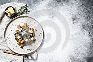 Pasta tortiglioni with black truffle, white mushroom, Cream Sauce and ricotta cheese. Gray background. Top view. Space for text