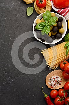 Pasta, vegetables, herbs and spices for Italian food on black background