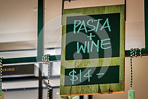 Pasta and wine for fourteen dollars sign