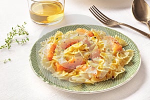 Pasta and wine, Italian dinner. Farfalle with smoked salmon and cream sauce