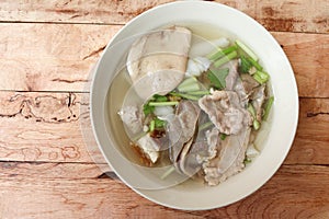 Paste of rice flour in the bowl isolated on wooden background closeup.