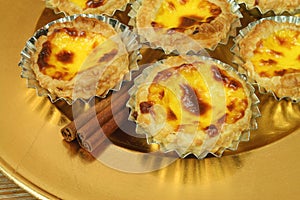 Pasteis de nata - egg tarts on golden plate photo