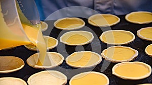 Pasteis de Nata, traditional Portuguese pastries, being made in a Lisbon bakery