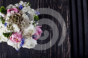 Pastel bouquet on dark old wood