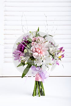 Pastel bouquet from pink and purple gillyflowers on white shutters