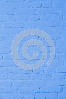 Pastel bright blue colored brickstone wall