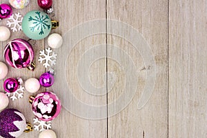 Pastel Christmas bauble side border on rustic white wood