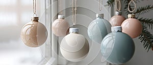 Pastel Christmas Ornaments Hanging by Window, Ideal for Modern Holiday Decoration. Banner