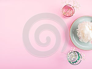 Pastel color dinnerware on pink background