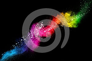 Pastel color dust particle splashing.Colorful powder explosion on black background