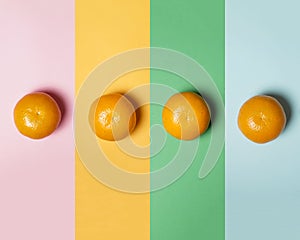 Pastel colored background concept with fresh oranges. Orange fruit pattern on colorful background  top view.