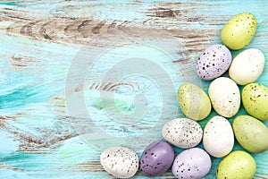 Pastel colored easter eggs on wooden background photo