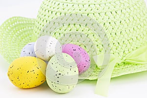 Pastel colored eggs with feminine green spring bonnet