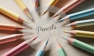 Pastel colored pencils arranged in a circular pattern on a light textured surface