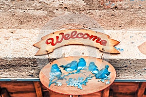 Pastel colored Wood sign written Welcome