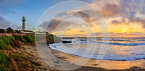 Pastel colors of sunset and silky water from long exposure of waves crashing by Pigeon Point Lighthouse on Northern California