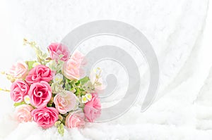 Pastel Coloured Artificial Pink Rose on white fur background