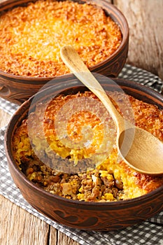 Pastel de Choclo Chilean Beef and Corn Casserole closeup in the bowl. Vertical photo