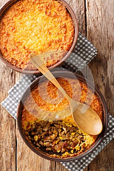 Pastel de Choclo Chilean Beef and Corn Casserole closeup in the bowl. Vertical top view photo